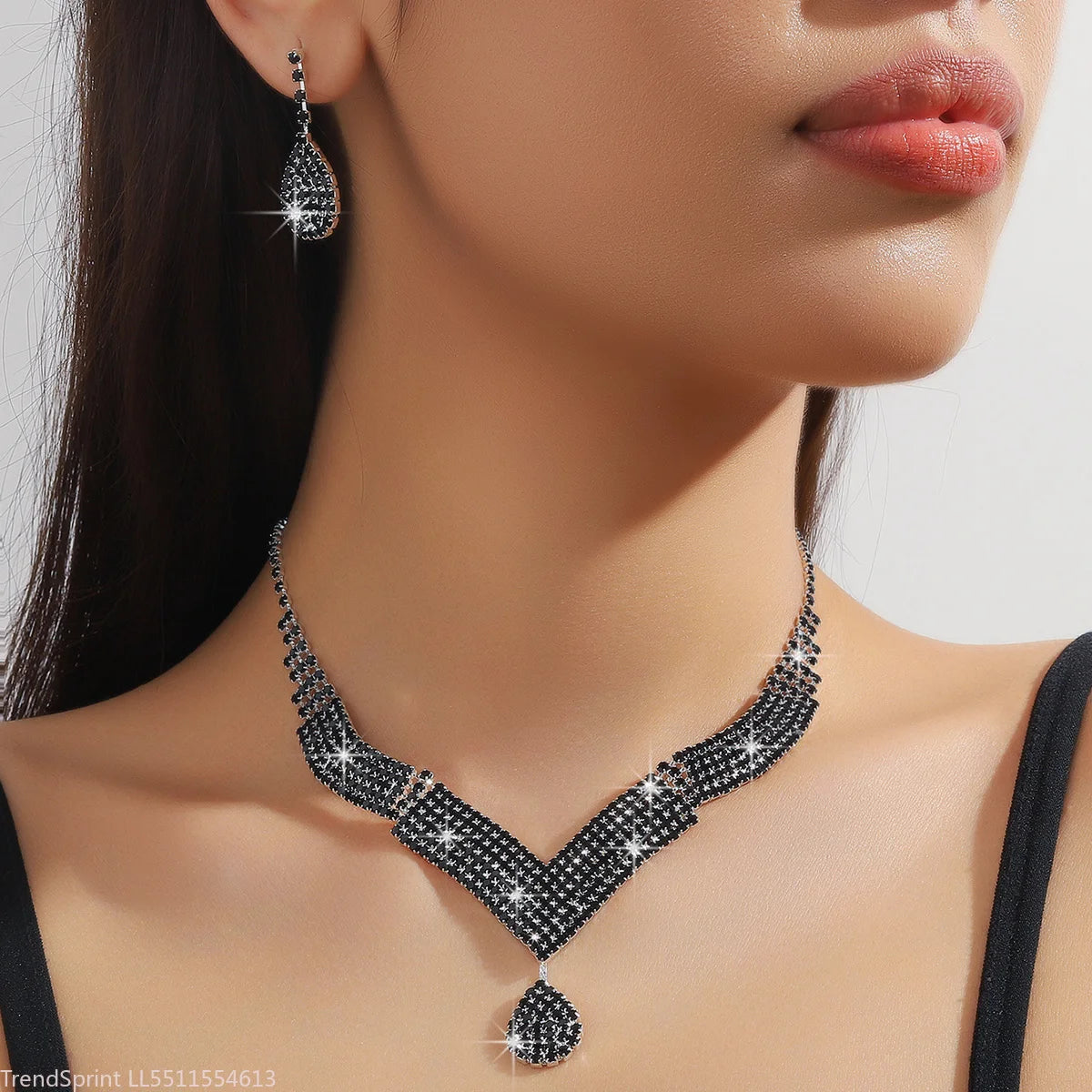 Fashion jewelry set with teardrop-shaped rhinestones, featuring gold-tone finish and intricate design by Corporación Turística.