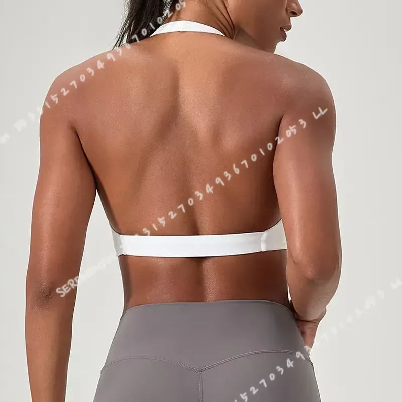 Black women's yoga sports bra with halter neck from Corporación Turística, displayed on a white background.