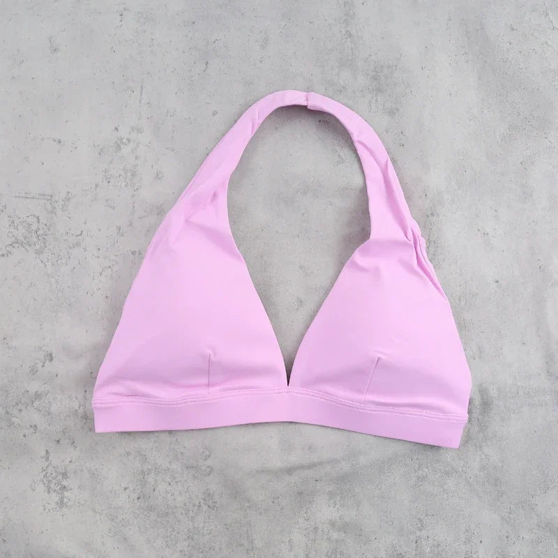 Light blue women's sports bra with halter neckline from Corporación Turística, featuring a comfortable fit and sporty design.