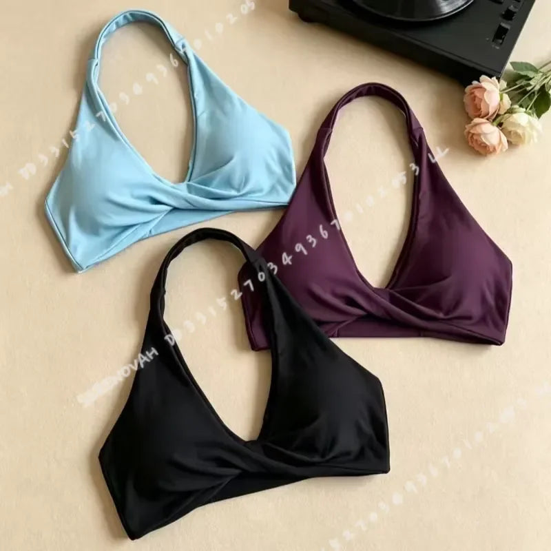 Scarlet red women's halter sports bra with open back, stylish and supportive athletic wear by Corporación Turística.