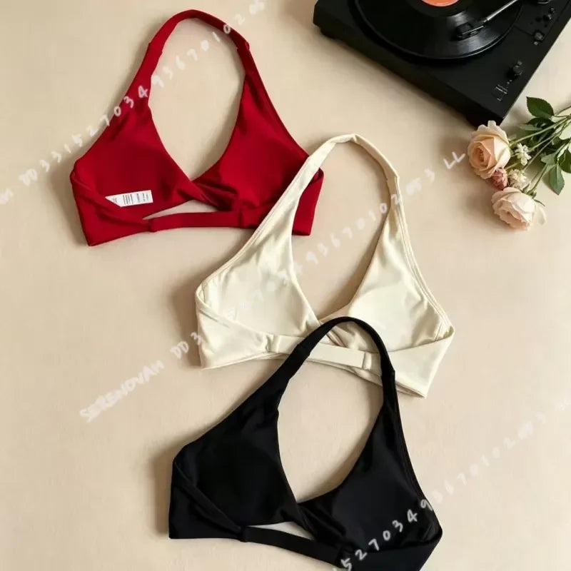 Scarlet red women's halter sports bra with open back, designed by Corporación Turística, featuring supportive fit for active wear.