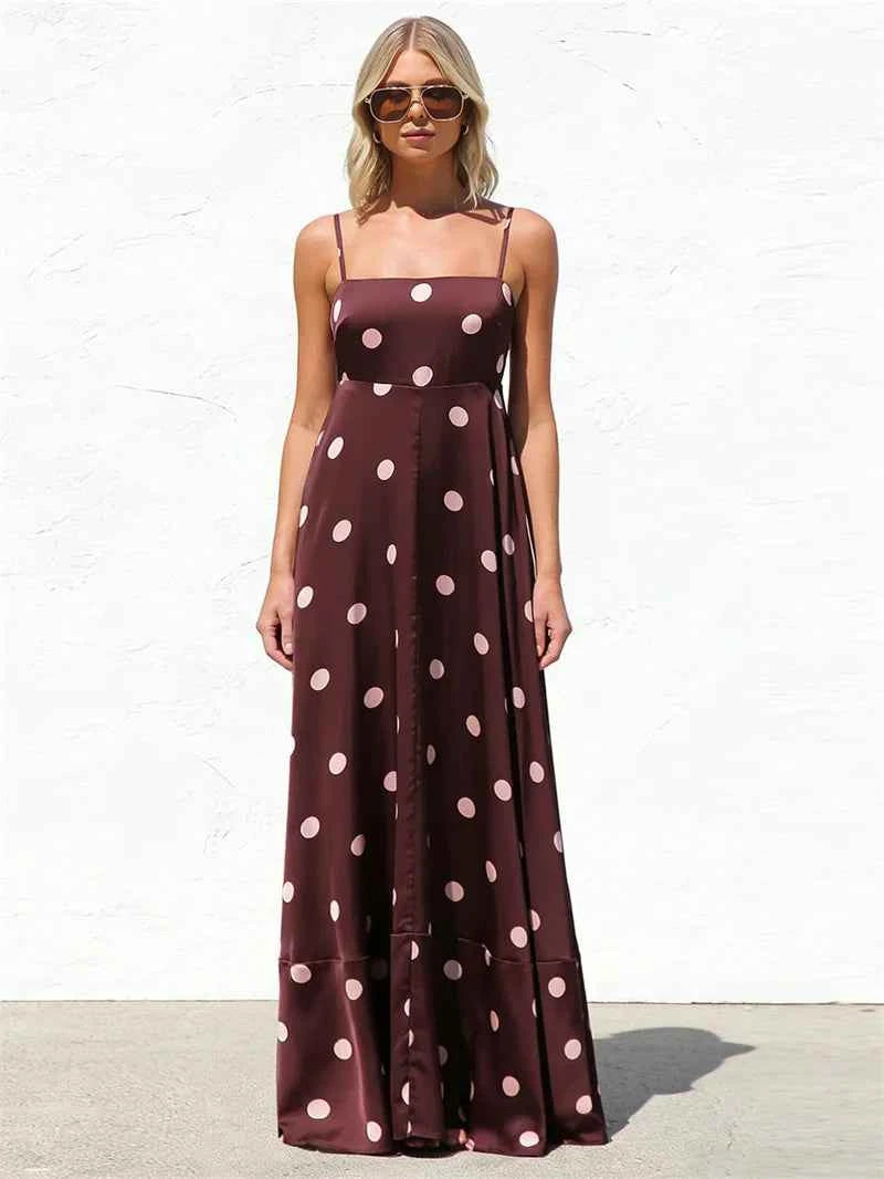 Fucsia long women's dress with thin spaghetti straps, elegant style by Corporación Turística, shown on a model.