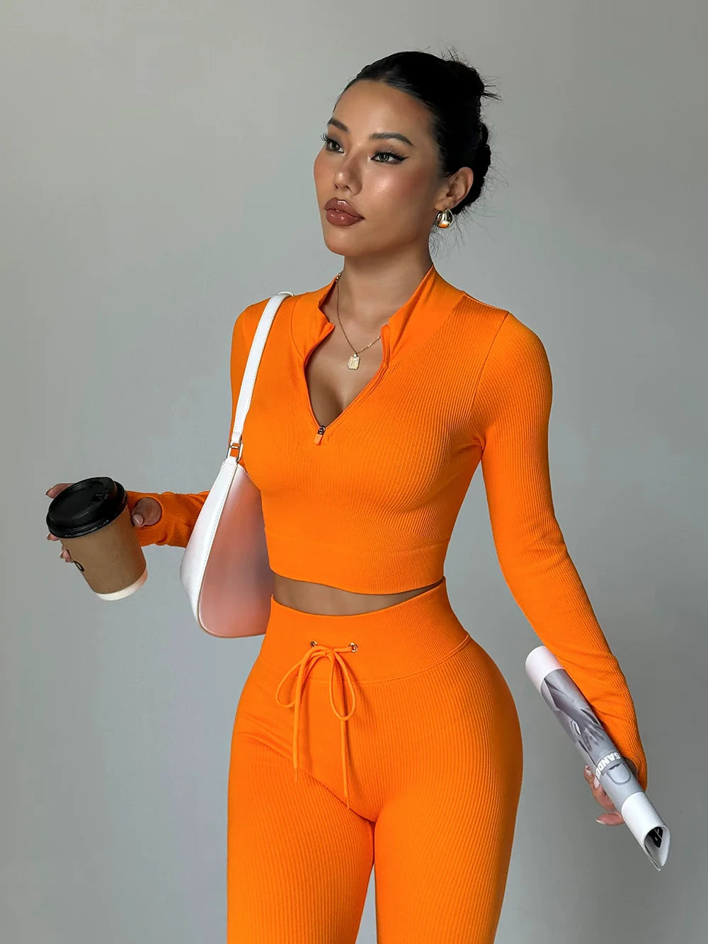 Fashionable two-piece yoga suit by Corporación Turística, featuring a stylish matching top and leggings for activewear.