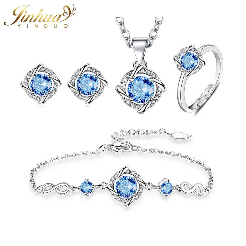 Silver jewelry set featuring classic designs from Corporación Turística, includes necklace and earrings with blue stones.