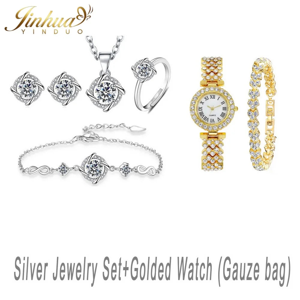 Sterling silver jewelry set with blue stone, featuring classic design, displayed on a white background.