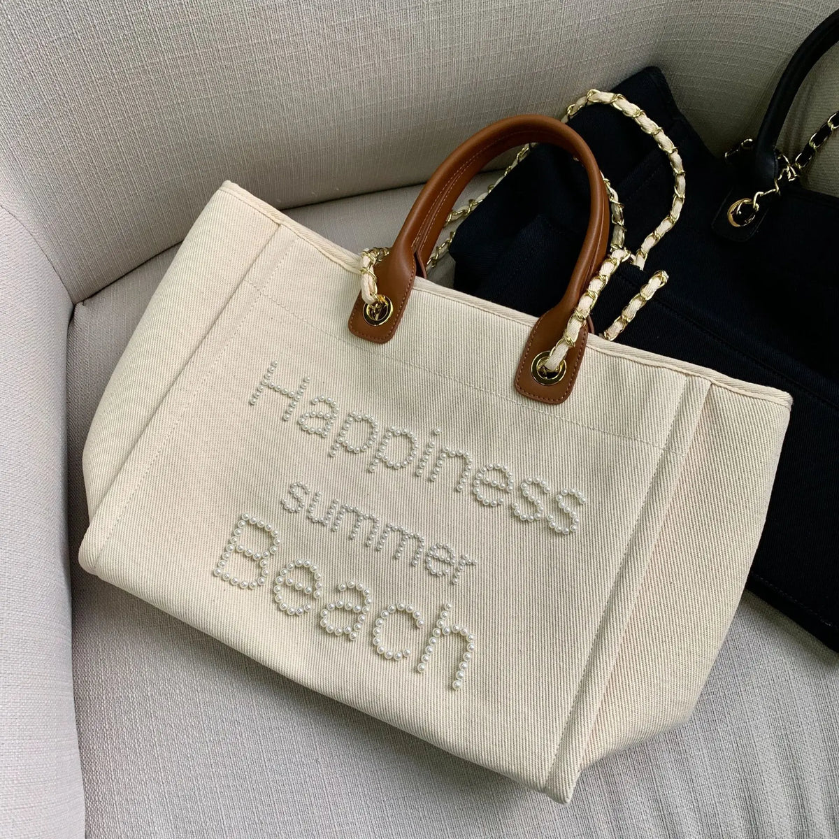 Large women's canvas tote bag with leather shoulder strap, genuine leather, spacious and stylish for everyday use.