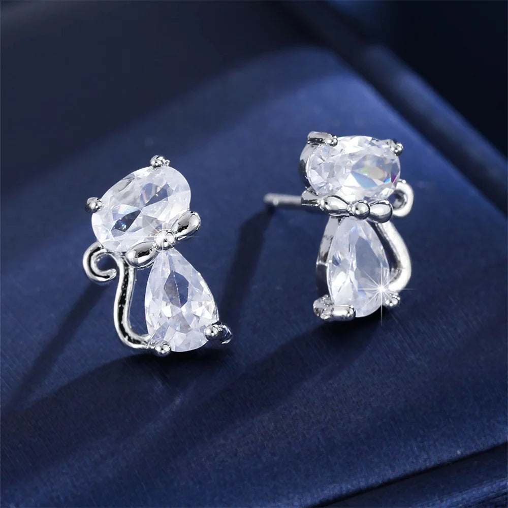 Small green cat-shaped earrings with zirconia stones, by Corporación Turística, featuring delicate feline design and sparkling accents.