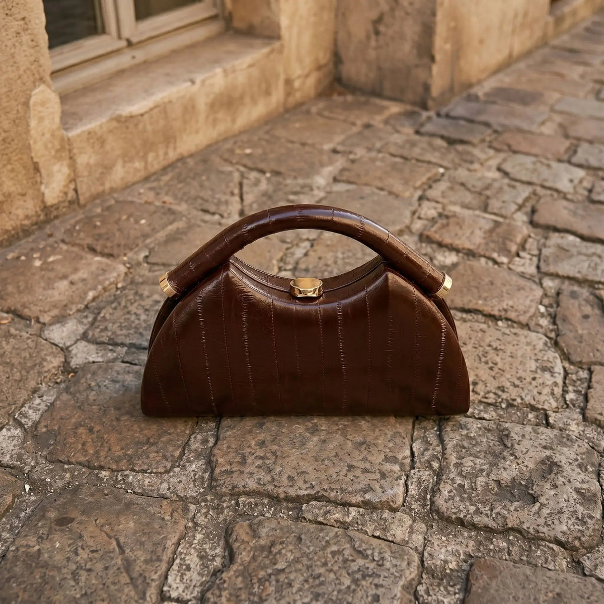 Gold Luna-shaped evening handbag for women, stylish clutch purse with a sleek design for formal occasions.