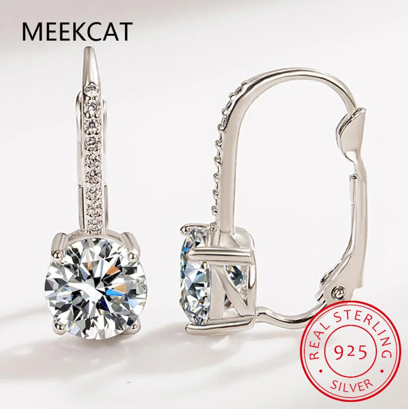 18K gold hoop earrings with 2-carat moissanite stones, elegant jewelry by Corporación Turística featuring sparkling gemstone accents.