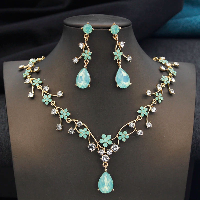 Gold water drop-shaped jewelry set for women by Corporación Turística, featuring earrings and necklace with elegant design.