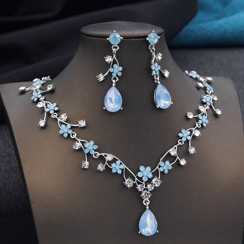 Gold and white water drop-shaped jewelry set for women featuring earrings and necklace from Corporación Turística.
