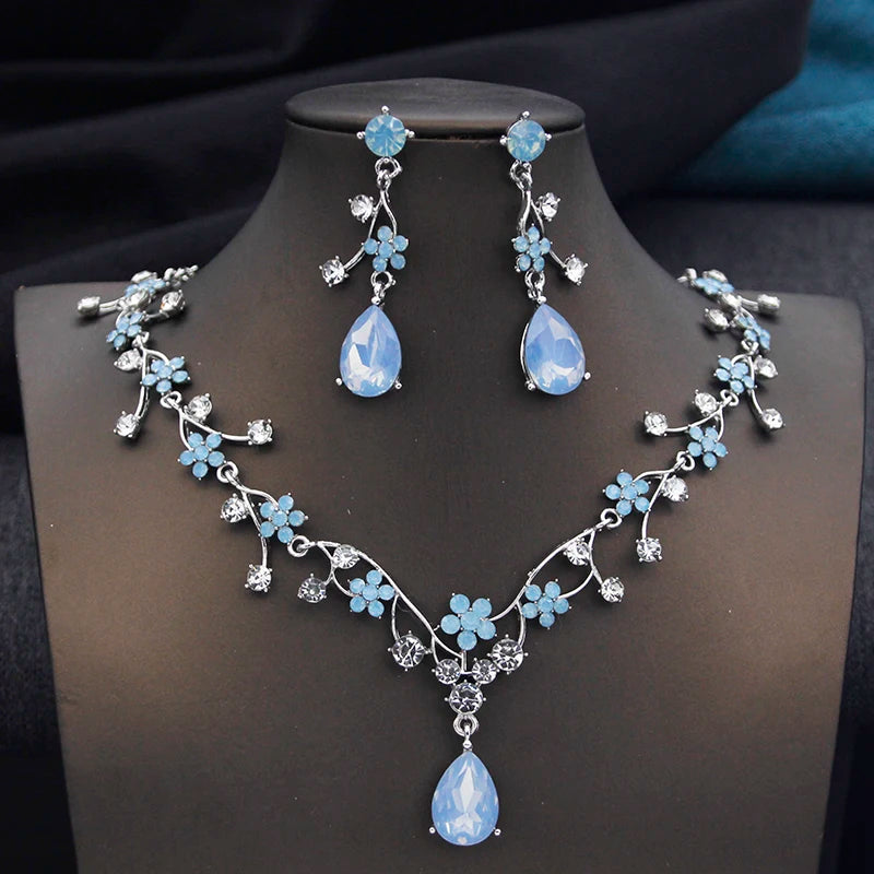 Gold and white water drop-shaped jewelry set for women, featuring matching earrings and necklace by Corporación Turística.