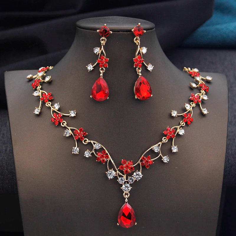 Gold and white water drop-shaped jewelry set for women featuring earrings and necklace by Corporación Turística.