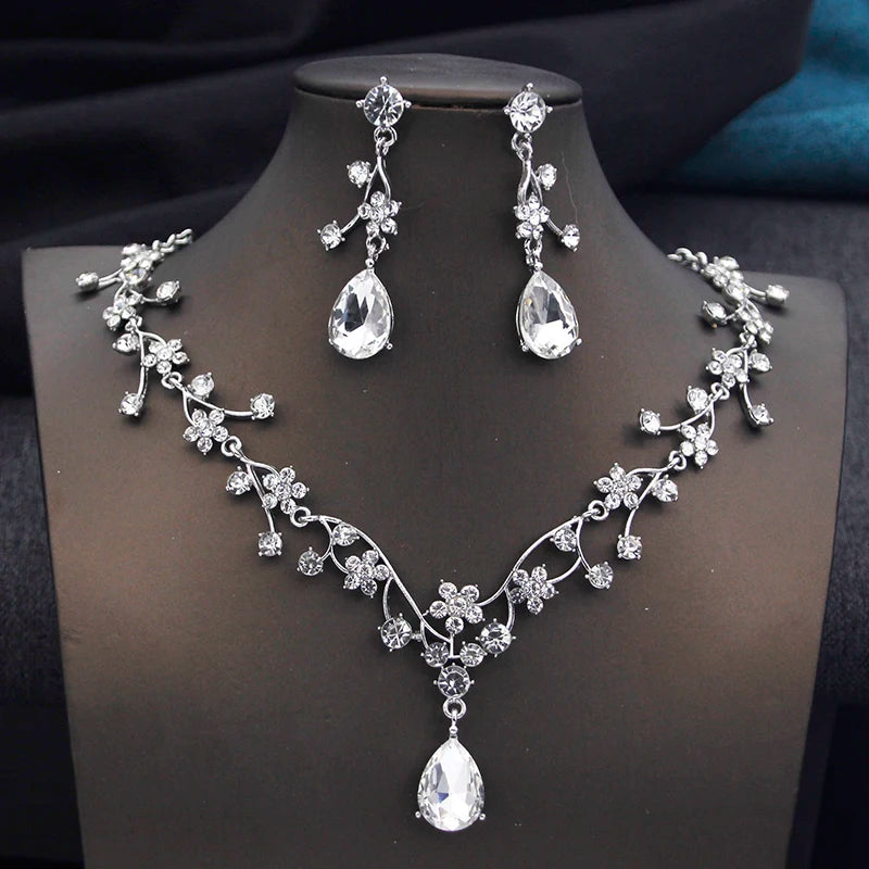 Gold and white water drop-shaped jewelry set for women by Corporación Turística, featuring earrings and necklace with elegant design.