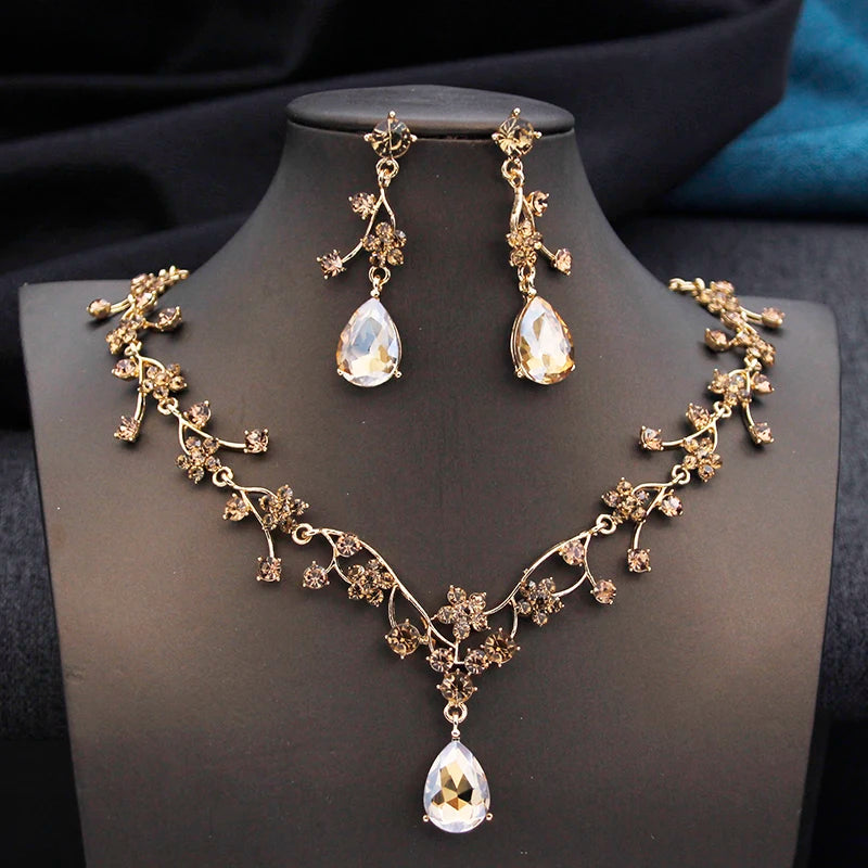 Gold and white water drop-shaped jewelry set for women by Corporación Turística, featuring earrings and necklace with elegant design.