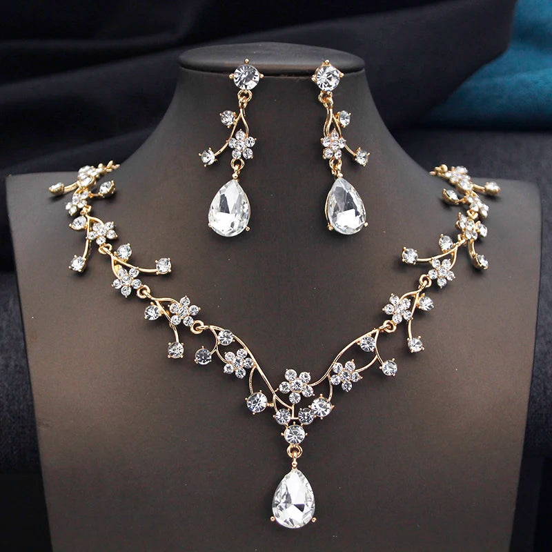 Gold and white water drop-shaped jewelry set for women by Corporación Turística, featuring earrings and necklace.