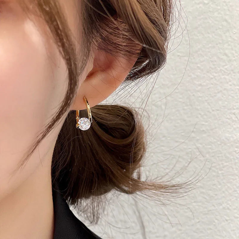 Gold and white Korean fashion zircon dangling earrings, stylish jewelry for women with intricate design details.