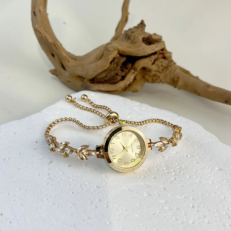 Elegant gold and black adjustable bracelet watch with crystal cord from Corporación Turística, featuring a stylish and sophisticated design.