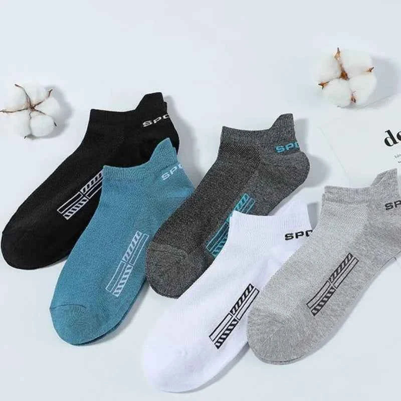 Set of five high-quality gray ankle socks for men from Corporación Turística, displayed in a neat arrangement.