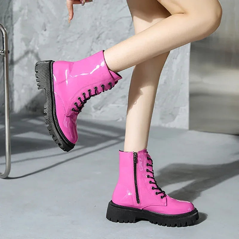 Pink women's lace-up motorcycle boots from Corporación Turística, featuring a stylish design and rugged sole.