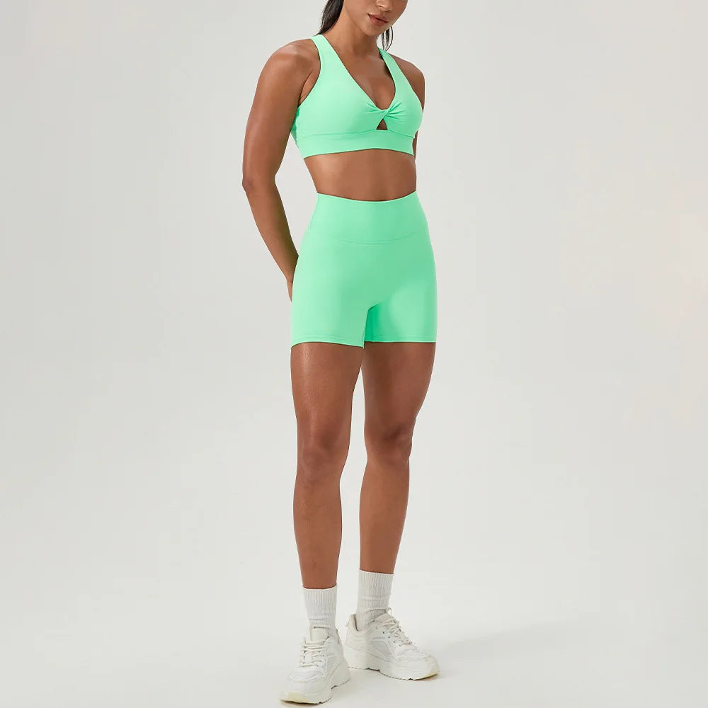 Green yoga set by Corporación Turística featuring a sexy sports bra and matching yoga bottoms, designed for active wear and style.