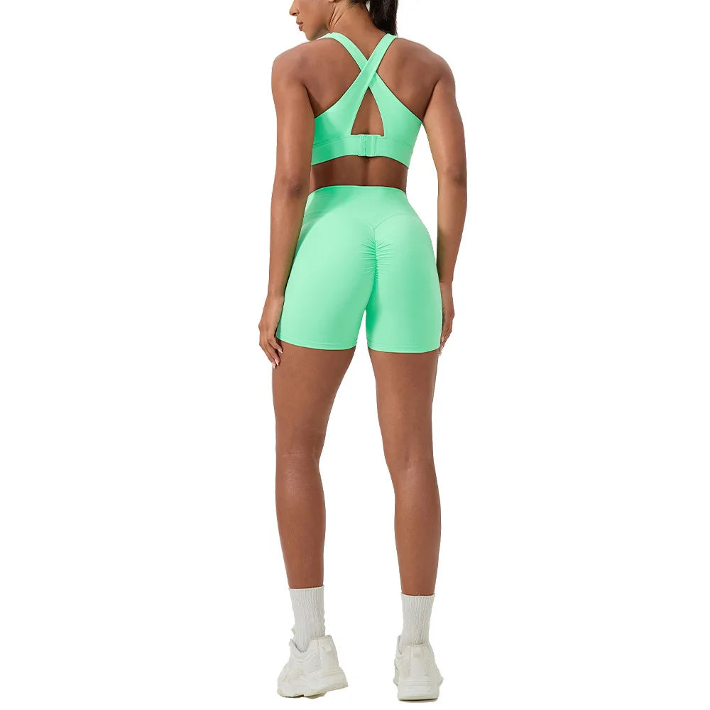 Green Naked Yoga Set by Corporación Turística featuring a sexy sports bra and matching yoga shorts, stylish and comfortable activewear.