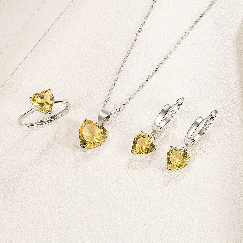 Silver jewelry set for women featuring necklaces and earrings made from 925 sterling silver, displayed on a green background.