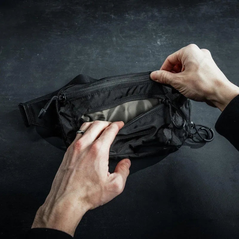Grey tactical waist bag for men, ideal for hiking and climbing, by Corporación Turística.