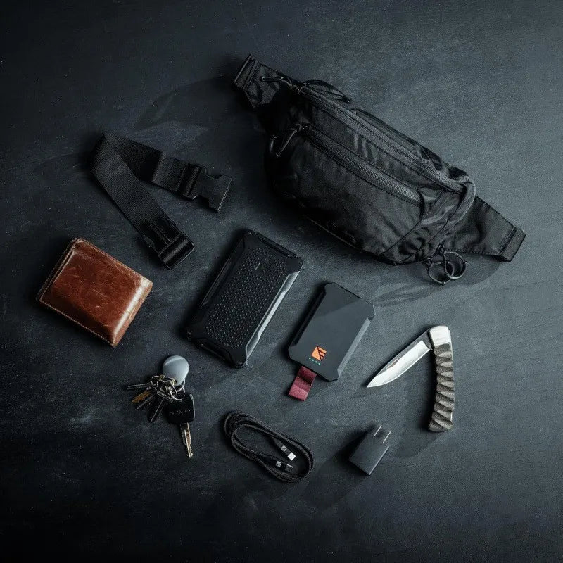Grey tactical waist bag for men by Corporación Turística, ideal for hiking and climbing activities.