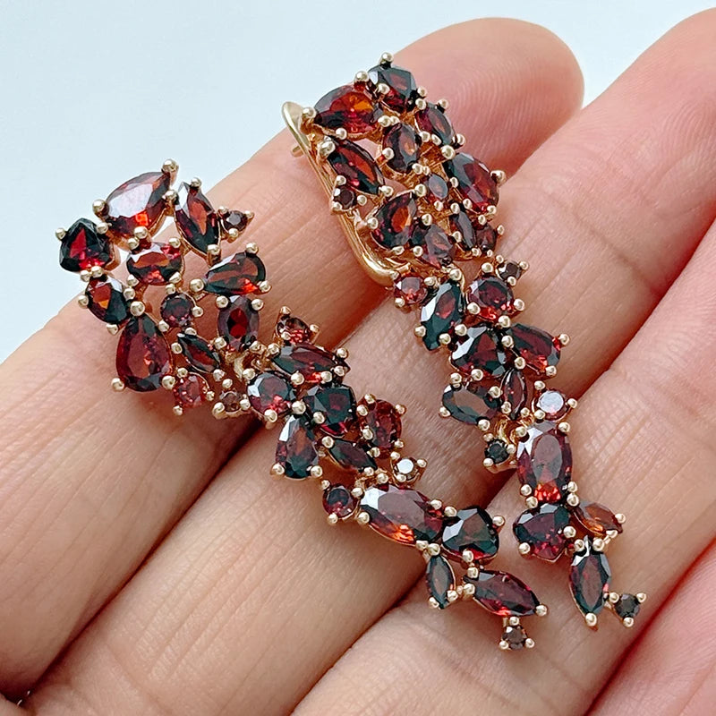 Kinel long earrings by Corporación Turística with sparkling red natural zirconia, featuring elegant dangle design.