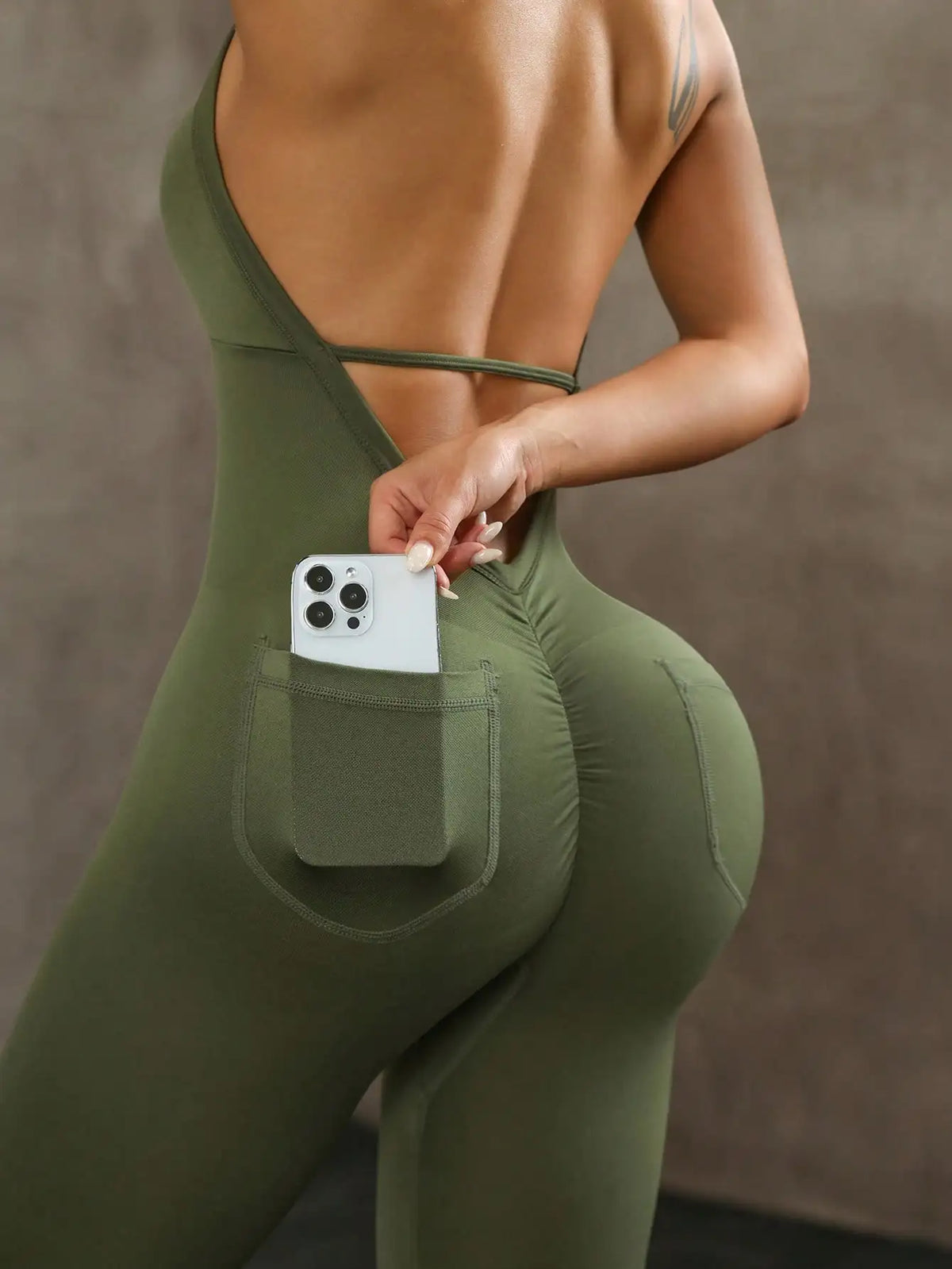 Black yoga compression leggings with backless, sleeveless design from Corporación Turística, ideal for active wear and flexibility.