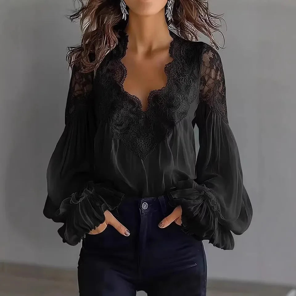 White lace blouse with V-neck and long sleeves, from Corporación Turística, shown on a hanger against a neutral background.