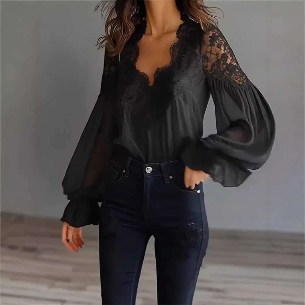 White lace blouse with deep V-neck and long sleeves, stylish top by Corporación Turística, detailed lace fabric and elegant design.