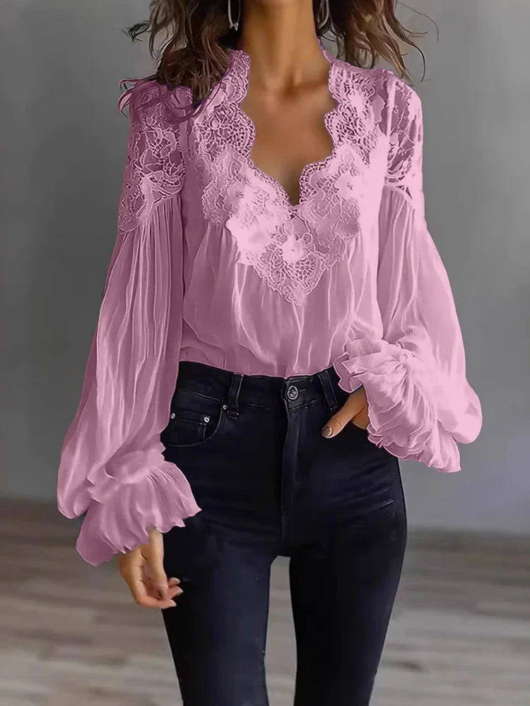 White lace blouse with deep V-neck and long sleeves by Corporación Turística, shown on a mannequin with intricate lace details.