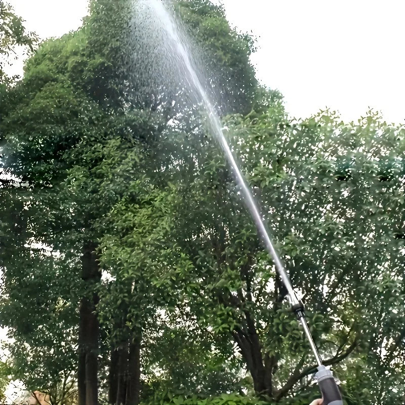 High-pressure water spray gun by Corporación Turística for car and garden cleaning, shown in use with water spraying from the nozzle.