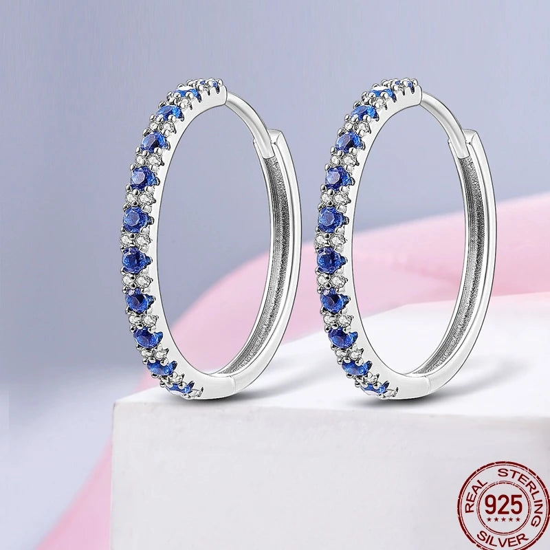 Colorful sterling silver 925 earrings with circular design from Corporación Turística, showcasing vibrant, eye-catching jewelry details.