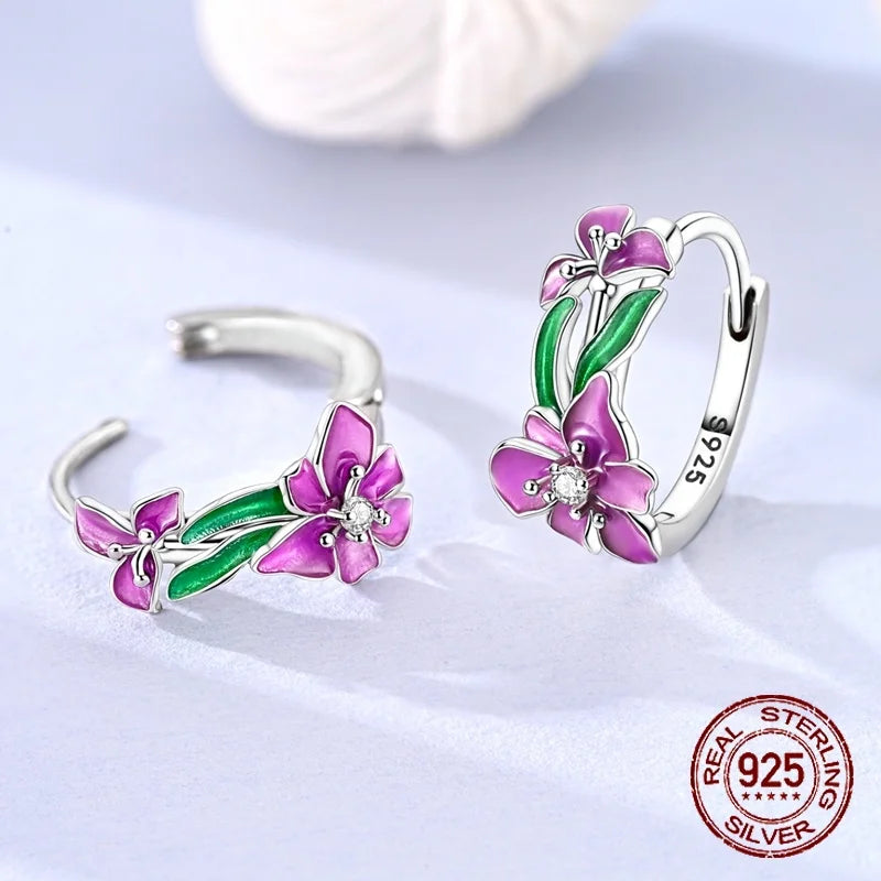Silver hoop earrings with leaf and flower designs, crafted by Corporación Turística, featuring intricate nature-inspired details.