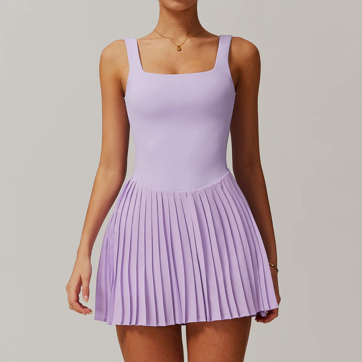 Lavender purple yoga set and tennis dress by Corporación Turística, featuring a fitted dress and matching activewear for women.