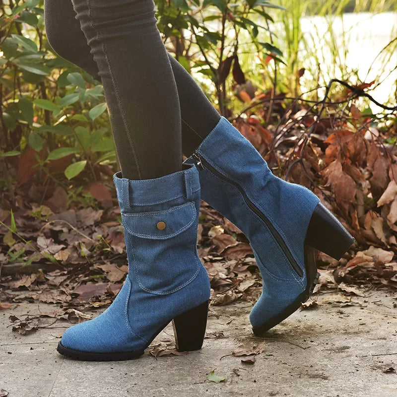 Light blue women's cowboy boots with pointed toes and block heels, featuring decorative stitching and Western style.