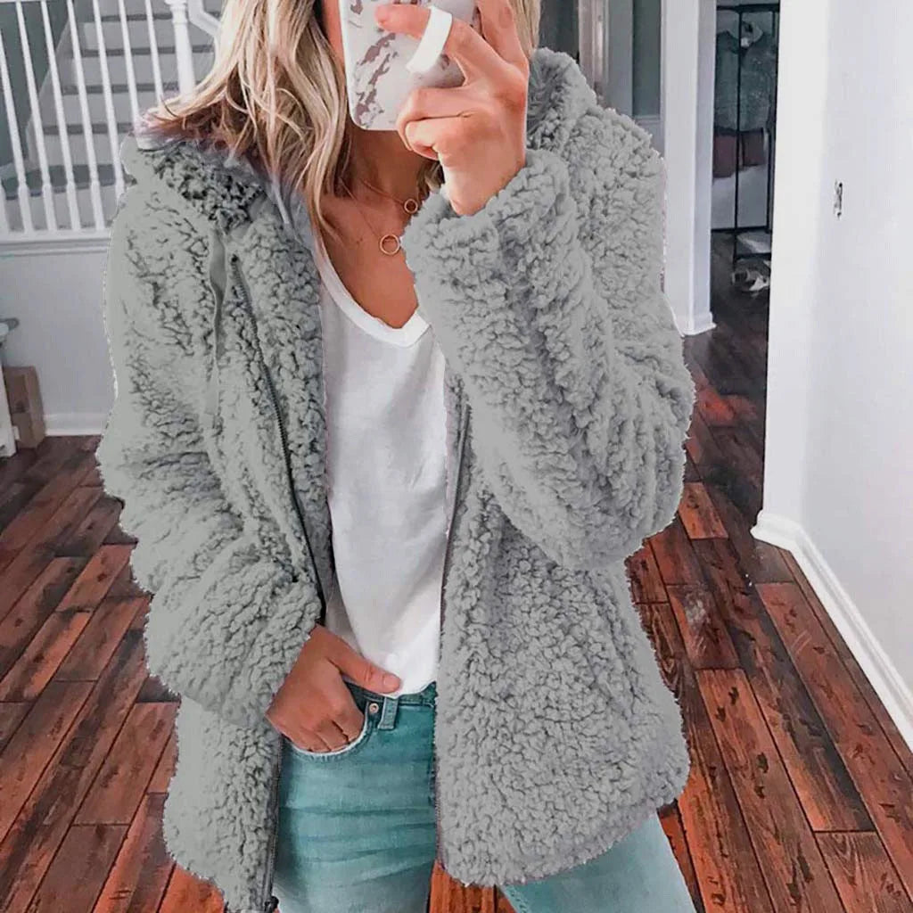 Light grey women's thick coat with hood and zipper, featuring a cozy design from Corporación Turística.