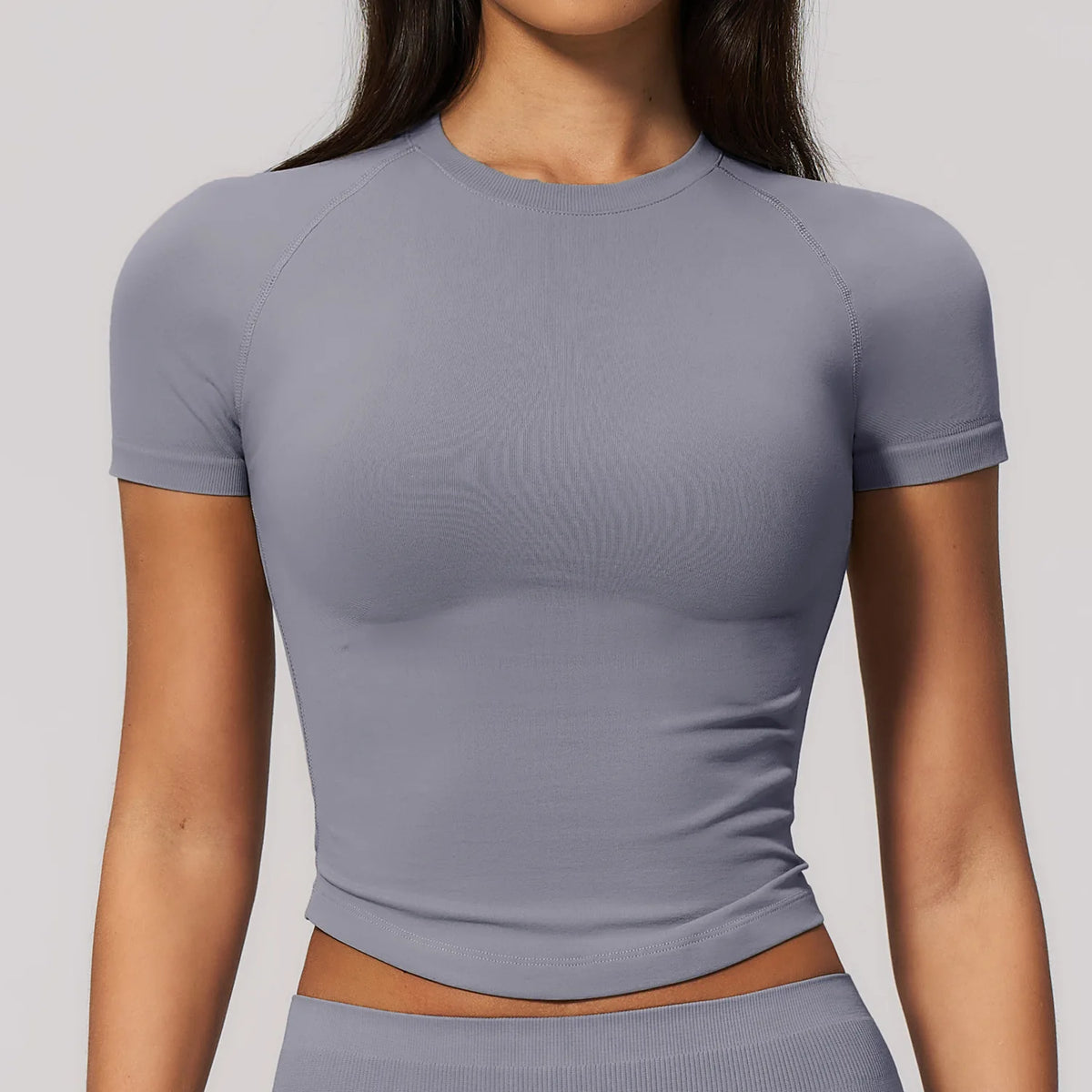Light khaki women's yoga crop top by Corporación Turística with round neck and short sleeves, perfect for active wear.
