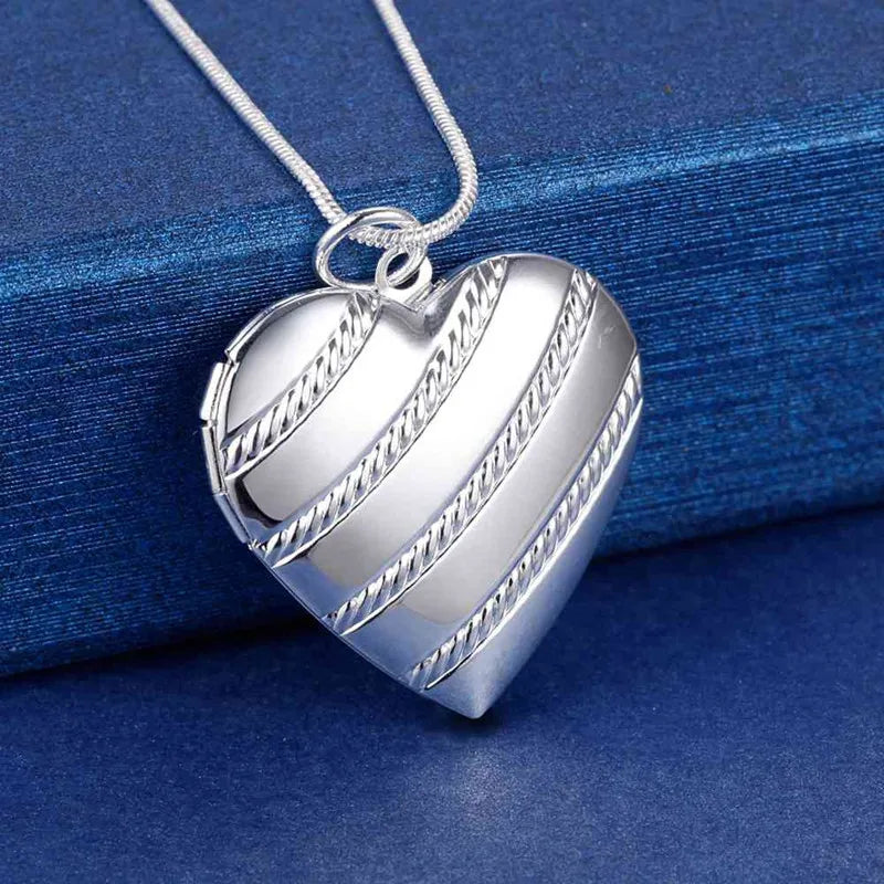 Sterling silver necklace with shell pendant, 40-75cm length, from Corporación Turística, featuring a seashell design in the image.