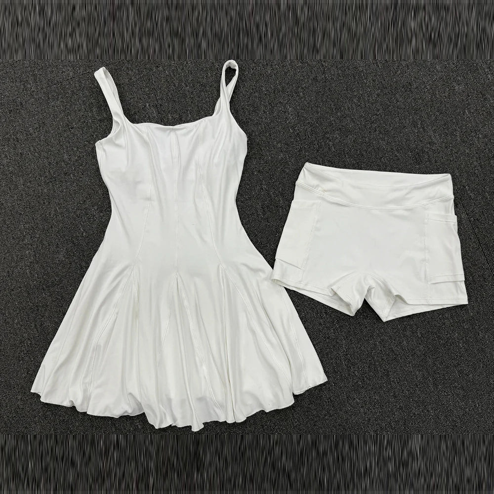 Marfil sleeveless backless tennis dress by Corporación Turística featuring a short design with pockets and sporty style.