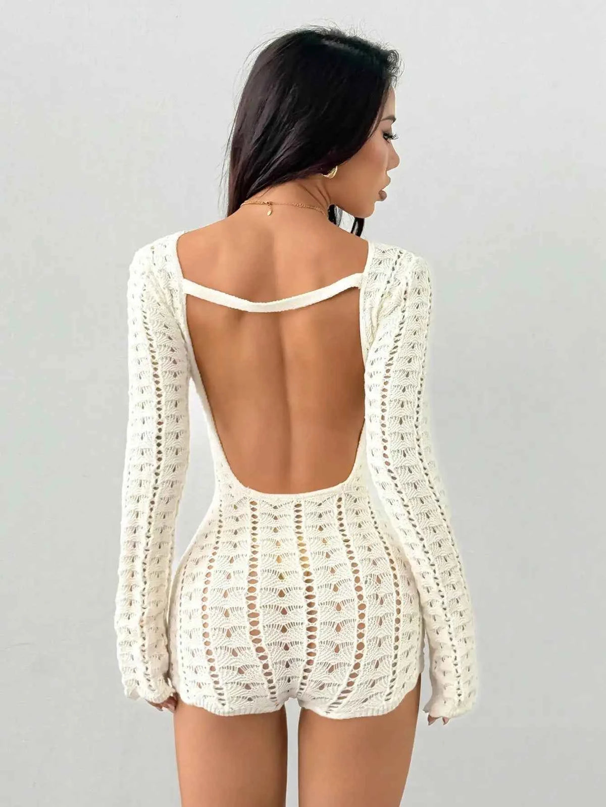 Long-sleeve women's crochet knit romper in ivory from Corporación Turística, featuring a stylish short design.