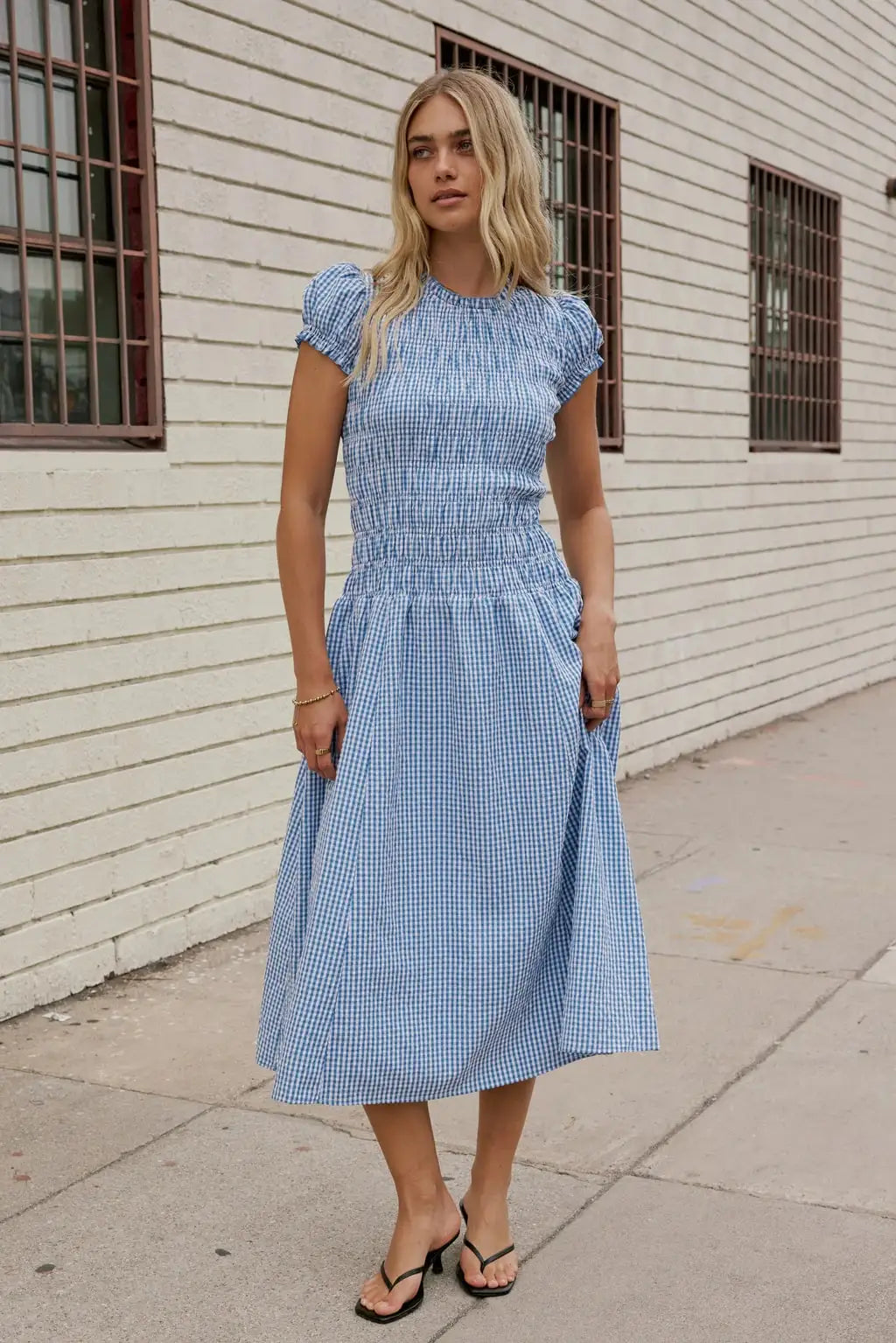 Elegant women's smocked dress with floral print from Corporación Turística, featuring a flattering fit and stylish design.