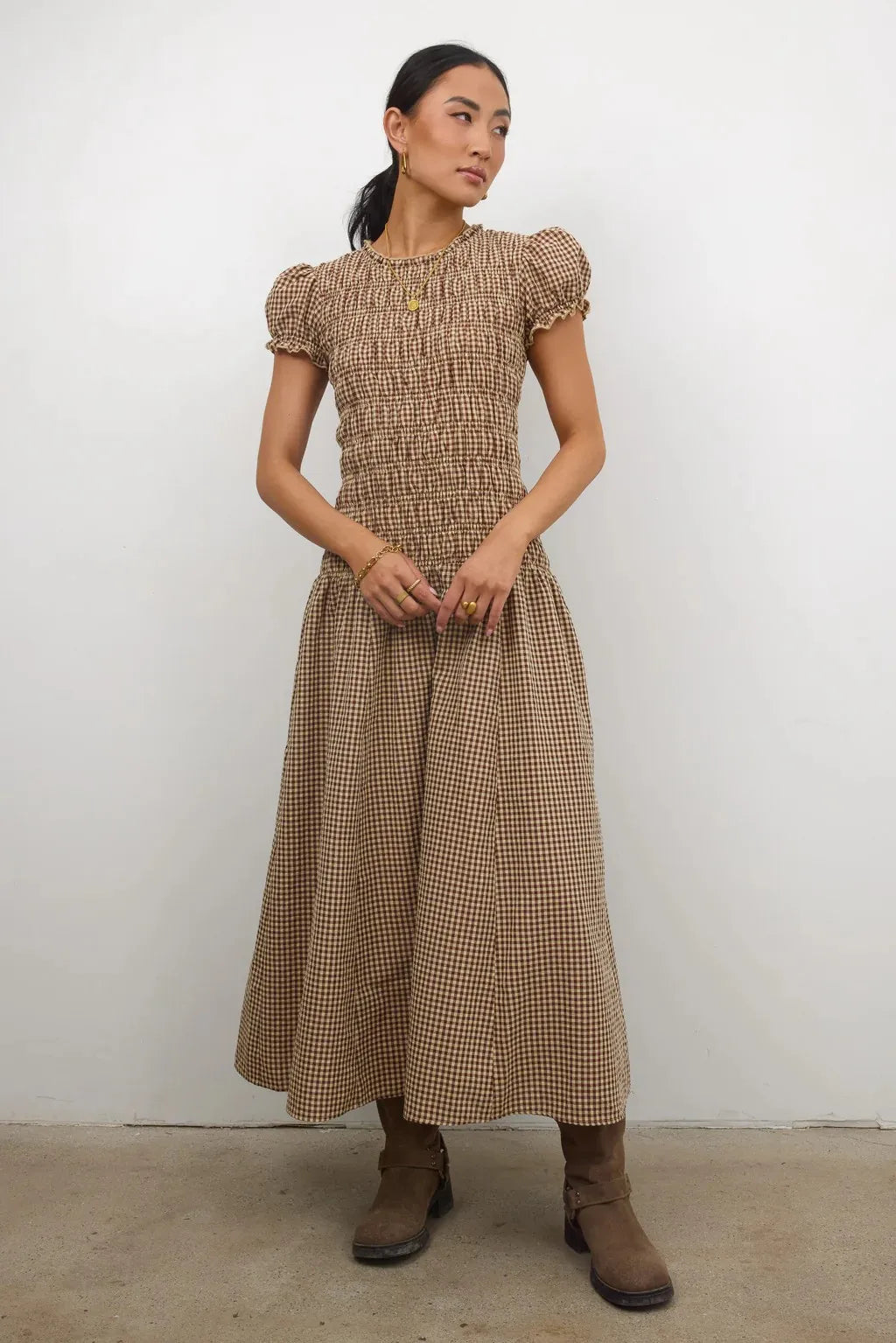 Elegant brown smocked dress for women with floral print, stylish and comfortable, perfect for casual or semi-formal occasions.