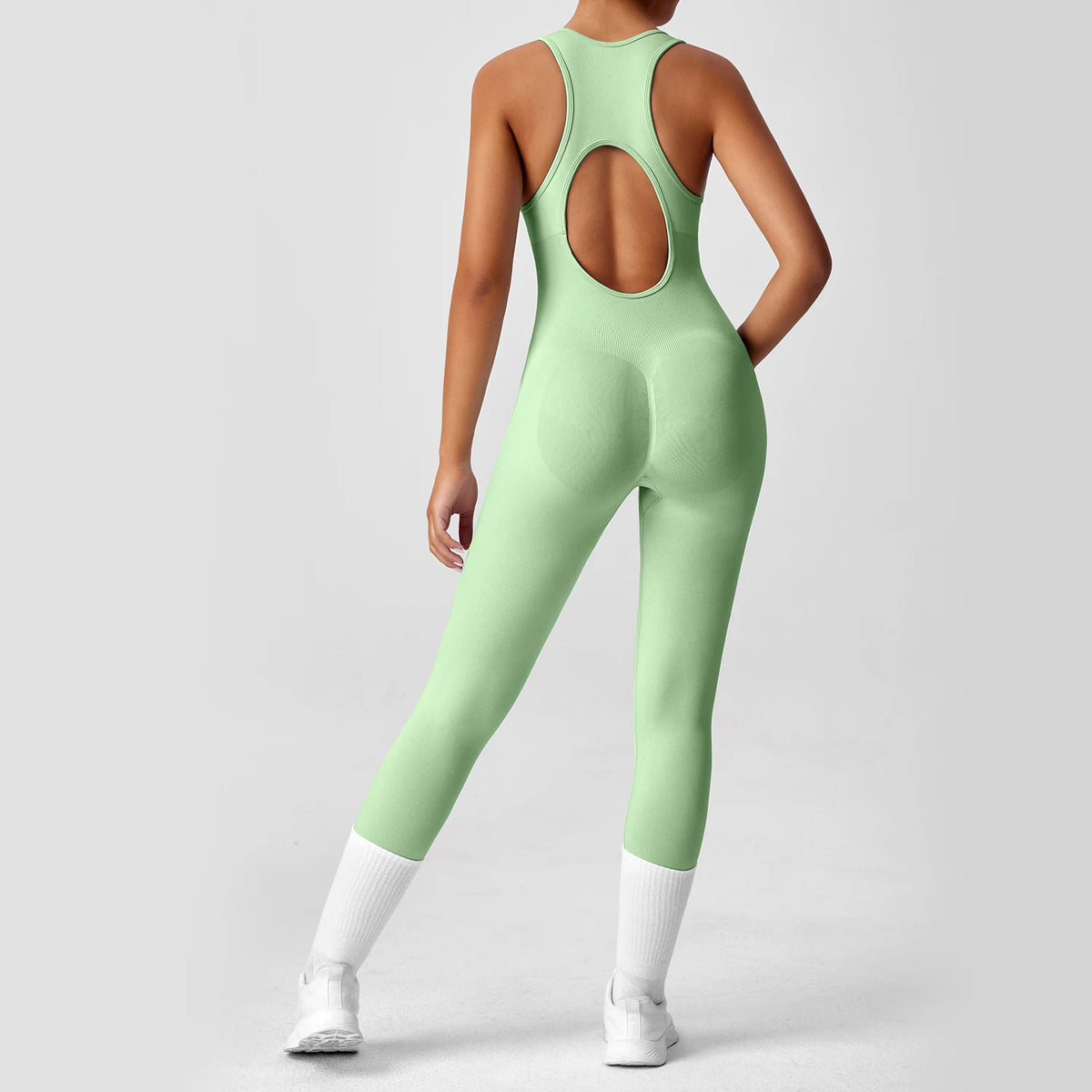 One-piece peach-colored yoga bodysuit with matching boot, from Corporación Turística, displayed flat on a white background.