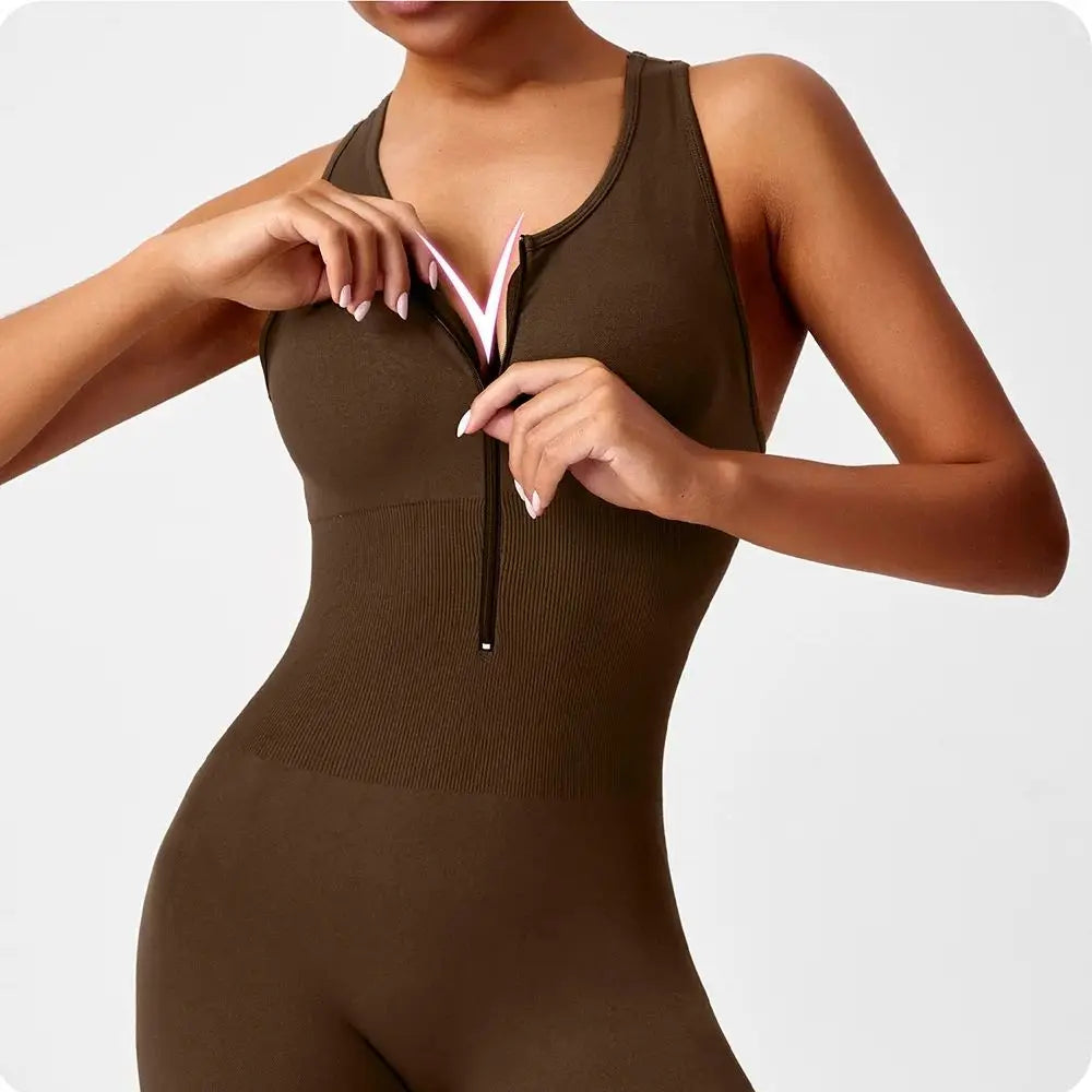 Peach-colored one-piece yoga bodysuit with matching booties from Corporación Turística, shown on a model.