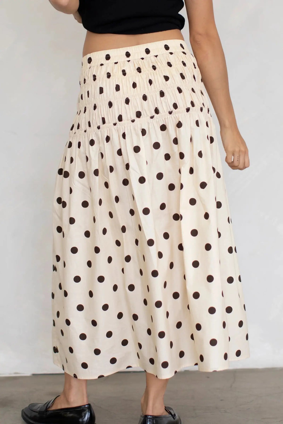 Long flowing gauze skirt with elastic waist and printed pattern, by Corporación Turística, shown in a warm brown color.