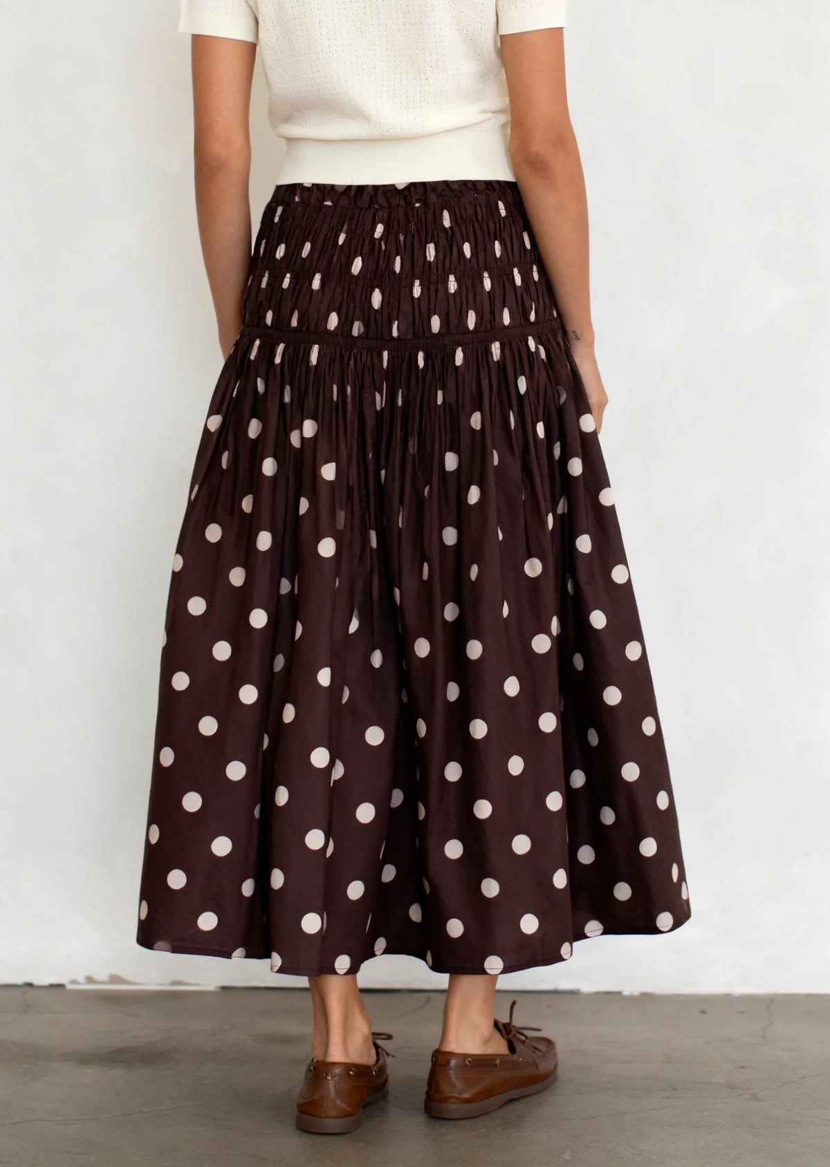 Long chiffon skirt with elastic waist and floral print, by Corporación Turística, shown in brown fabric.